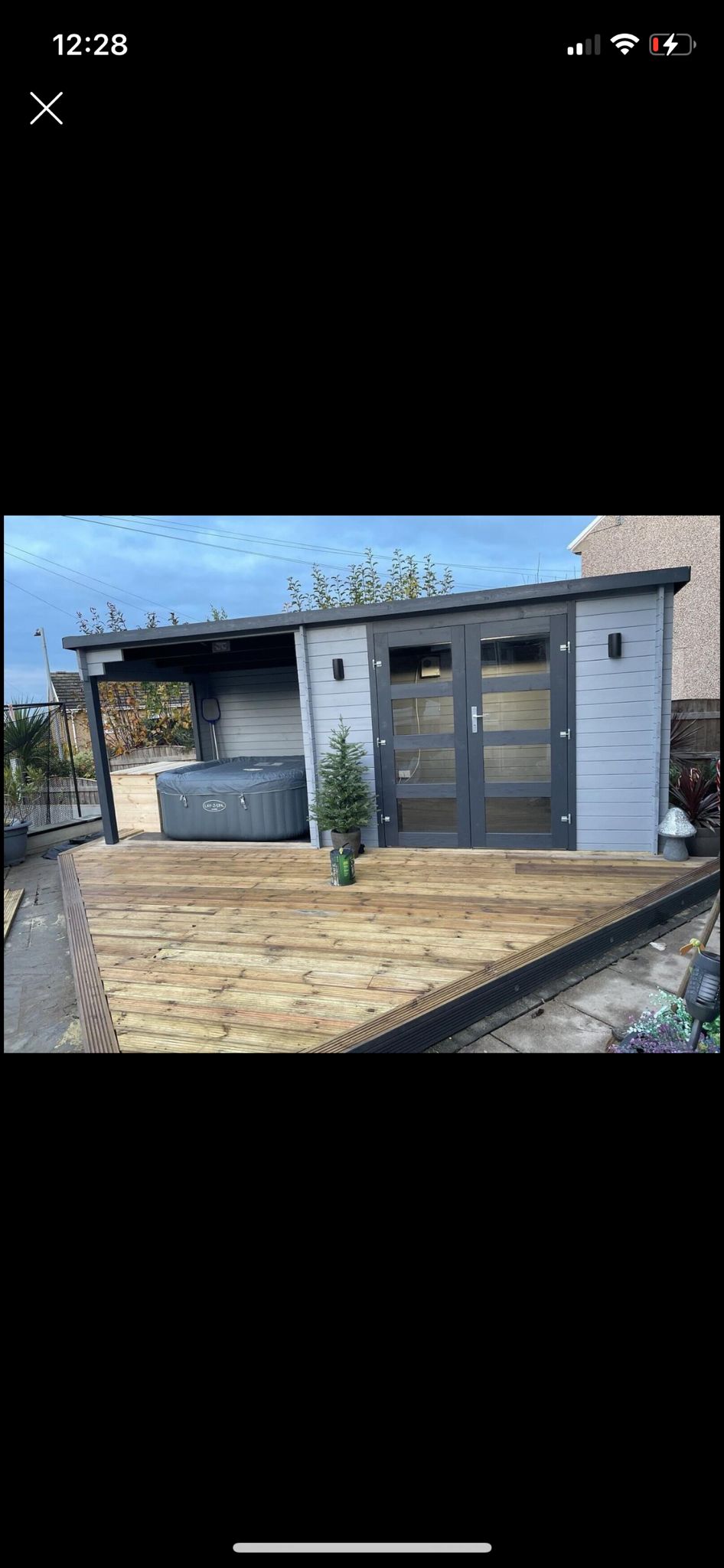 grey wooden building and hot tub